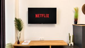 a television on a wall with the text netflix on it at Ambra Luxury Suite 14 in Kallithea Halkidikis