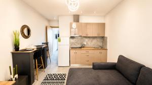 a living room with a couch and a kitchen at Ambra Luxury Suite 14 in Kallithea Halkidikis