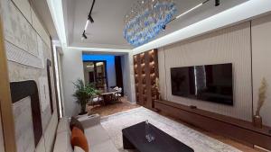 a living room with a fireplace and a tv at Zafran Smart Luxury Suite in Dushanbe
