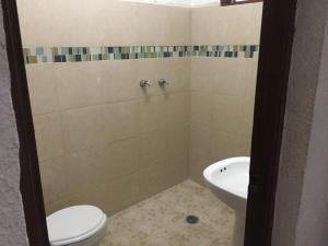 a bathroom with a toilet and a sink at Hotel Paraiso Express in Veracruz