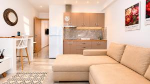 a living room with a couch and a kitchen at Ambra Luxury Suite 15 in Kallithea Halkidikis