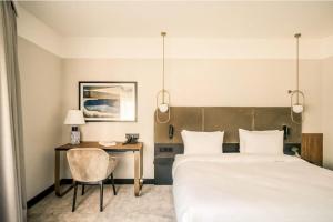 a hotel room with a bed and a desk at Royal VIP in Kołobrzeg +21 photos