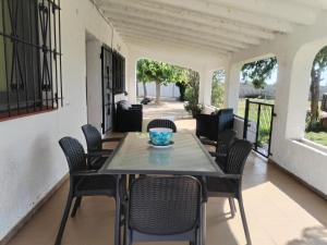 a patio with a table and chairs on a porch at Chalet Garcia in Deltebre