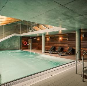 a swimming pool in a building with at Royal VIP in Kołobrzeg