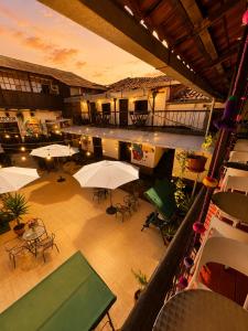 an overhead view of a patio with tables and umbrellas at Terra House Hostel in Cusco