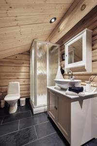 a bathroom with a toilet and a sink at Utsikten in Vågsli +22 photos