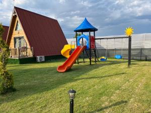a playground with a slide in a yard at denizkızı bungalow in Zumrutkaya