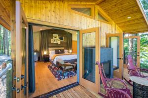 a room with a bedroom and a bed and a fireplace at Skamania Lodge in Stevenson