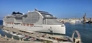 a large cruise ship docked in a harbor at The Oyster - F in Il-Furjana