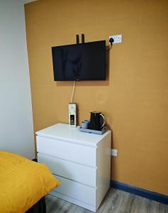 a room with a bed and a tv on a wall at Phoenix in Derry Londonderry