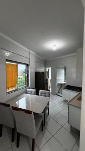 a kitchen with a table and chairs in a room at Ed. Odilon Vieira ap.205 in Vitória da Conquista
