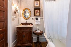 a bathroom with a sink and a mirror at The Reynolds Mansion in Asheville