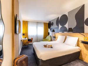 a hotel room with a large bed with teddy bears on it at Mercure Metz Centre in Metz