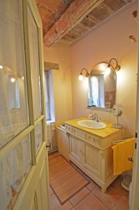 a bathroom with a sink and a mirror at Mas Antonin in La Garde-Adhémar +17 photos