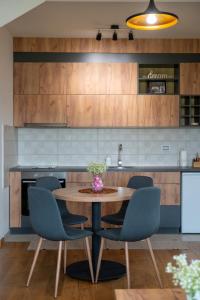 a kitchen with a wooden table and chairs at Vila Katalina Spa & Resort in Zlatibor