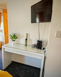a white desk in a room with a microwave at Phoenix in Derry Londonderry