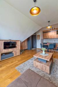 a living room with wooden cabinets and a table at Vila Katalina Spa & Resort in Zlatibor