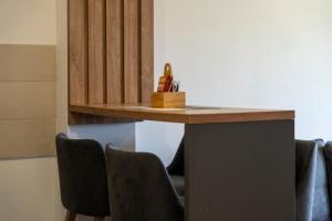 a counter with chairs in a room with a table at Vila Katalina Spa & Resort in Zlatibor +38 photos
