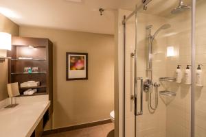 a bathroom with a shower with a glass door at Delta Hotels by Marriott Montreal in Montreal