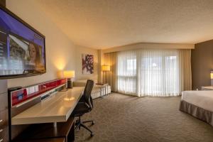 a hotel room with a bed and a flat screen tv at Delta Hotels by Marriott Montreal in Montreal