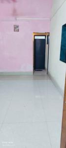 a room with a door and a white tile floor at Peaceful Stay in Malvan +2 photos
