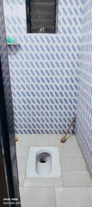 a bathroom with a toilet in a blue and white wall at Peaceful Stay in Malvan