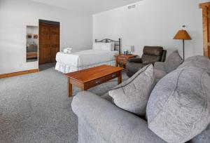 a living room with a couch and a bed at 1BR Mountain View Studio with Fireplace Deck Views in Fort Collins