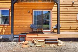 two chairs sitting on the front porch of a house at 1BR Mountain View Studio with Fireplace Deck Views in Fort Collins