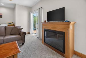 a living room with a television on top of a fireplace at 1BR Mountain View Studio with Fireplace Deck Views in Fort Collins +23 photos