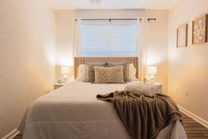 a bedroom with a large bed with a window at Spacious 3 Bed Condo Near ETSU in Johnson City