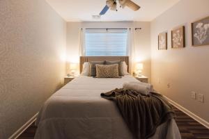 a bedroom with a large bed with a window at Spacious 3 Bed Condo Near ETSU in Johnson City
