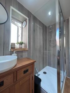 a bathroom with a tub and a sink and a shower at Forge Cottage in Polperro +40 photos