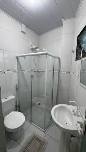 a bathroom with a shower and a toilet and a sink at Ed Odilon Vieira 304 in Vitória da Conquista