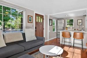 a living room with a couch and a kitchen at The McKinley Cottage in Boise