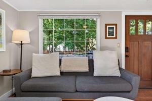 a living room with a couch and a large window at The McKinley Cottage in Boise