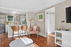a living room with a kitchen and a table and chairs at The McKinley Cottage in Boise +37 photos