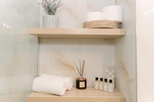 a shelf with towels and other items on it at Fissas Rooms in Syvota +163 photos