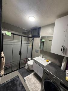 a small bathroom with a toilet and a sink at Lefkali HOME in Çınarlık +27 photos