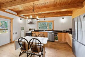 a kitchen with a table and chairs and a refrigerator at Cabin on Private 8-acre Lake in Clearwater
