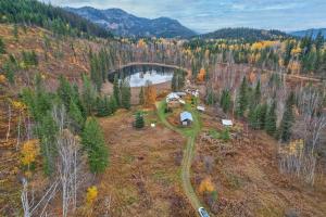 an aerial view of a house on a hill with a bridge at Cabin on Private 8-acre Lake in Clearwater