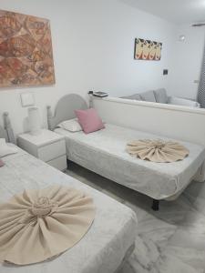 a room with two beds and a couch at il centro delle vacanze in Playa de las Americas +33 photos