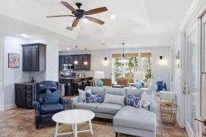 a living room with a couch and a ceiling fan at St George Island Bay Front Pool in St. George Island