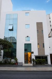 a white building with a glass door at Deville Inn in Lima