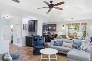 a living room with a couch and a ceiling fan at St George Island Bay Front Pool in St. George Island