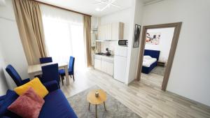 a living room with a blue couch and a table at Summerland Sea & Lake in Mamaia