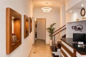 a hallway with a staircase with a tv on a wall at Deville Inn in Lima