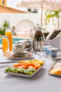 a plate of carrots and other vegetables on a table at Elsi Pousada in Búzios