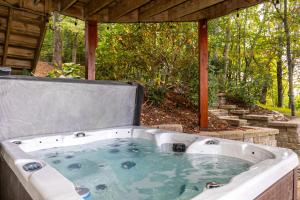 a jacuzzi tub sitting under a gazebo at Windswept Vistas in Boone
