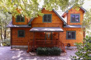 a wooden house with a porch in front of it at Windswept Vistas in Boone