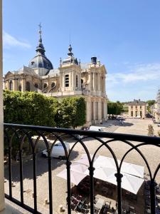 a view of a building from a balcony at L’ESPERANCE in Versailles
